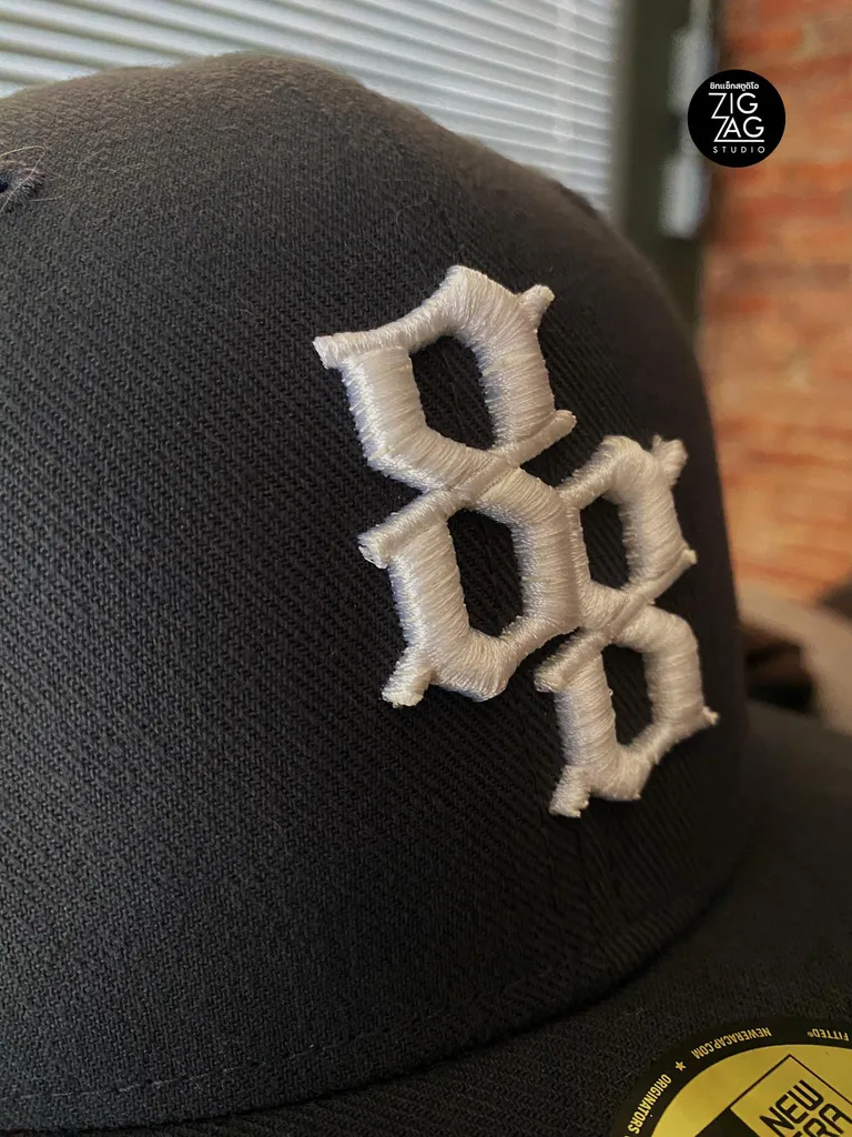Raised puff embroidery on a cap crown.