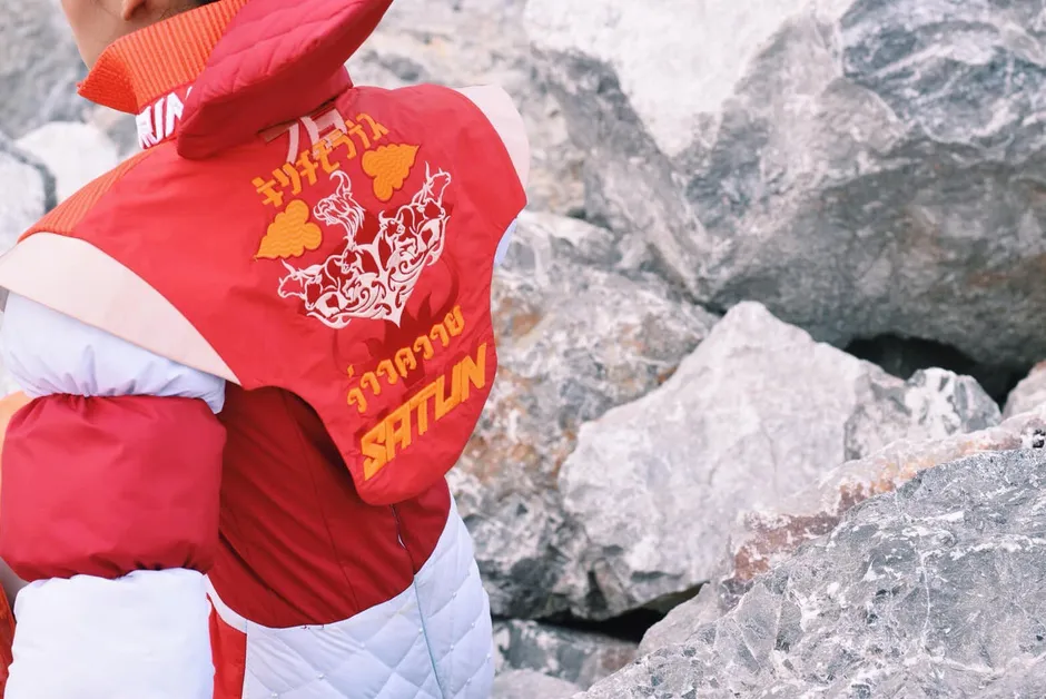 Thai lettering embroidered on quilted outerwear.